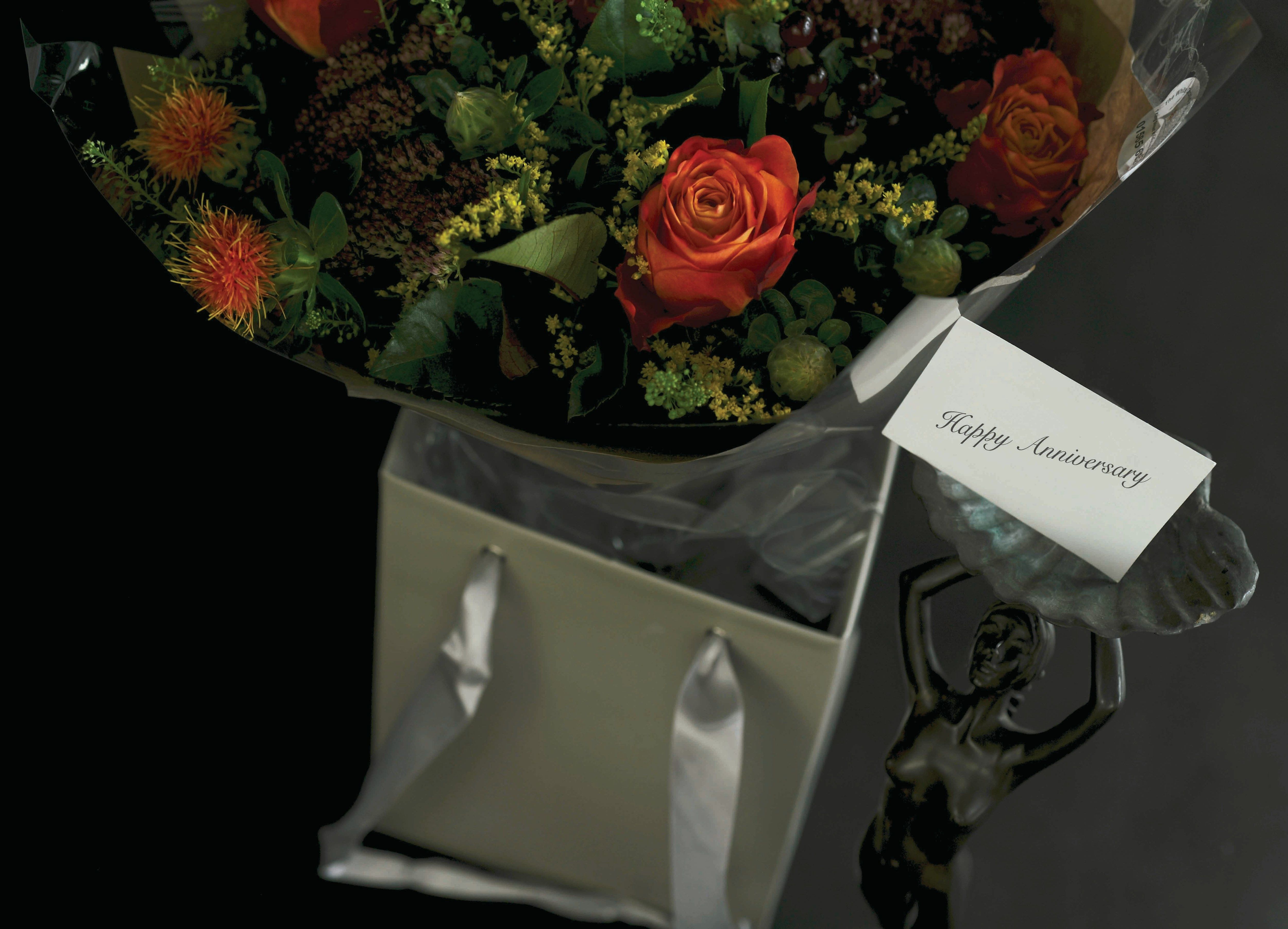 a bouquet of flowers is wrapped in clear cellophane