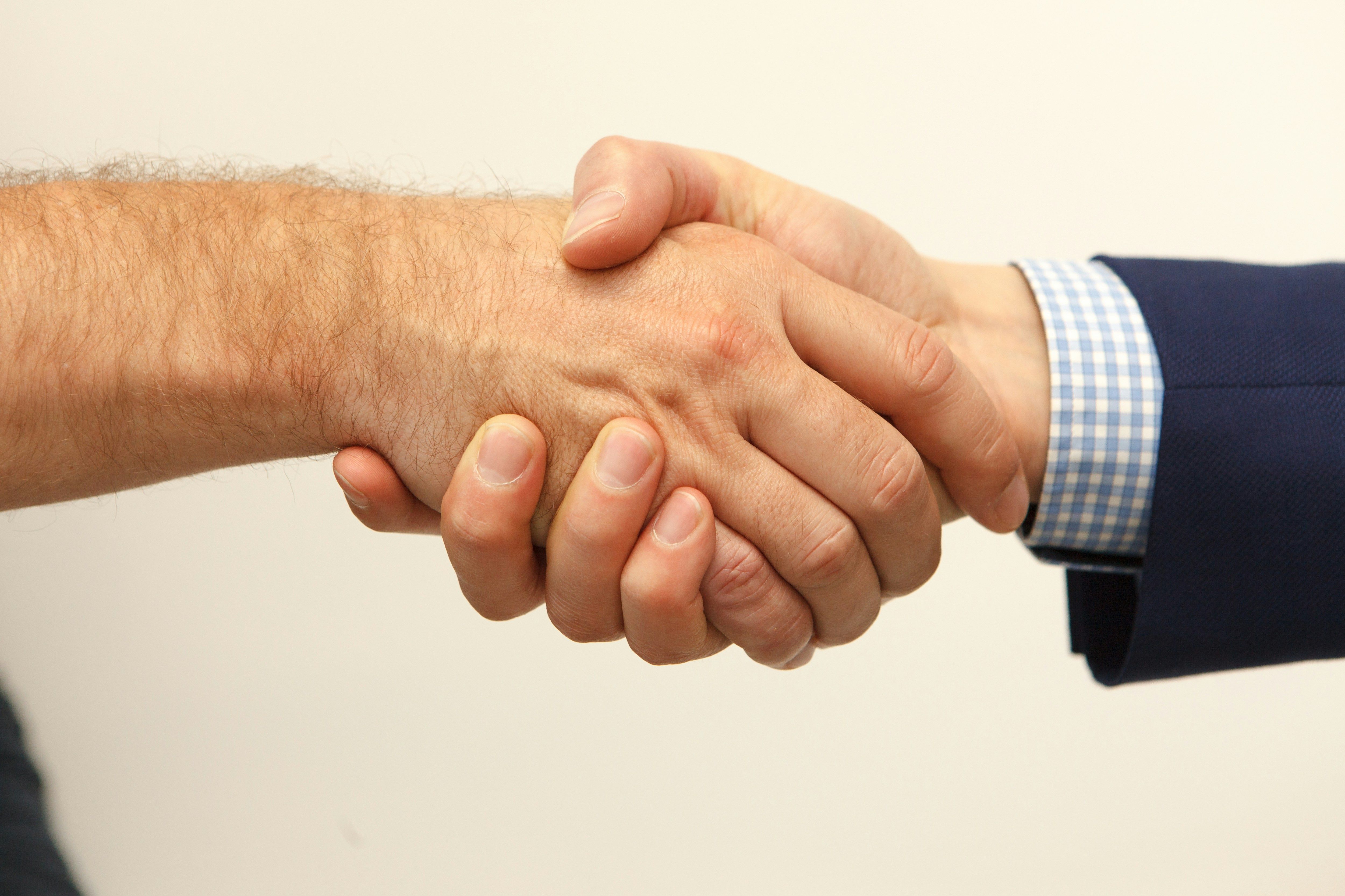 a close up of two people shaking hands