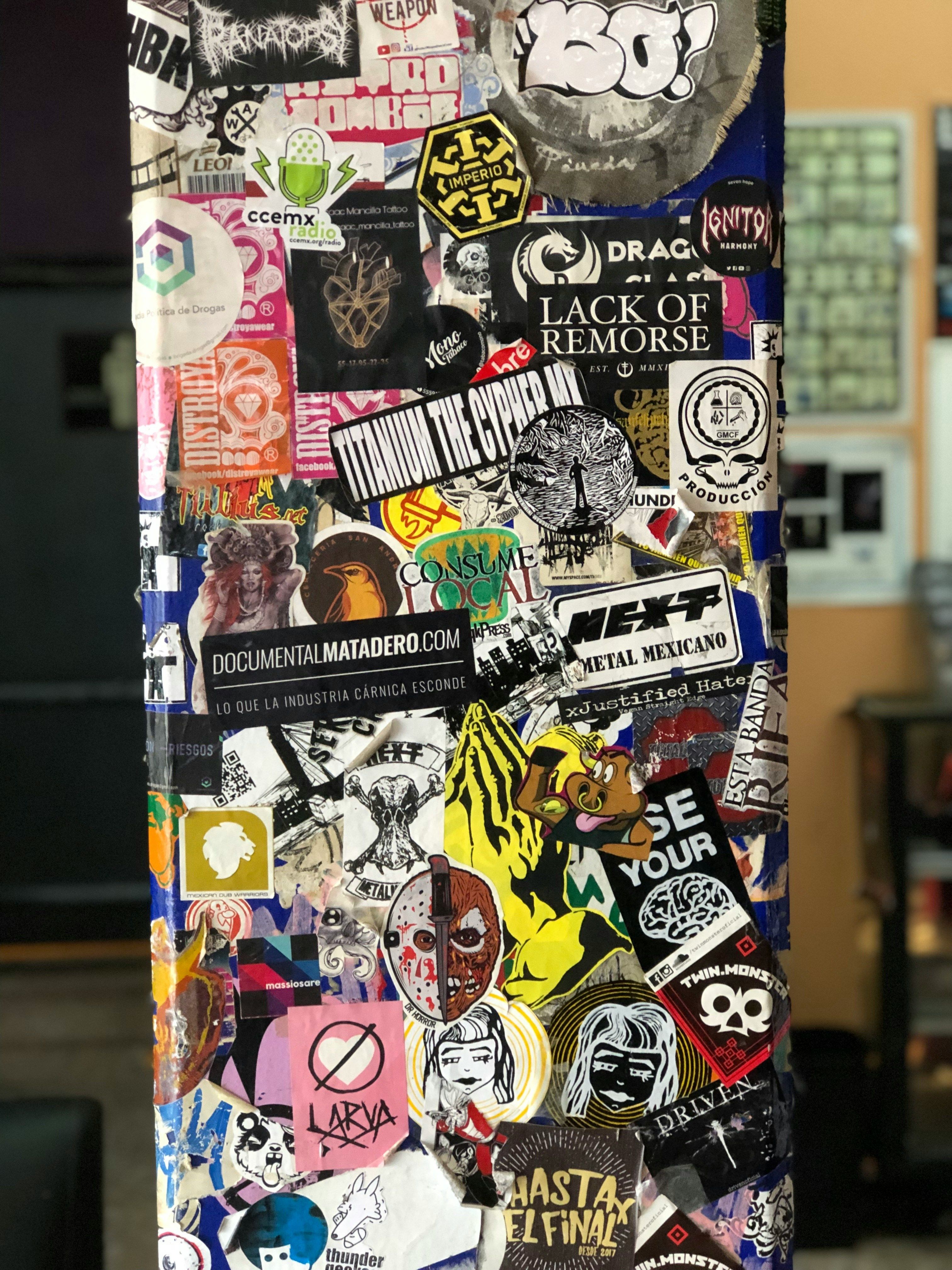 a refrigerator covered in lots of different types of stickers